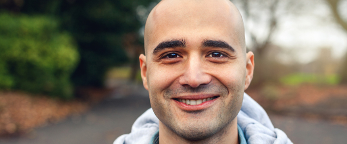 bald guy in business attire smiling